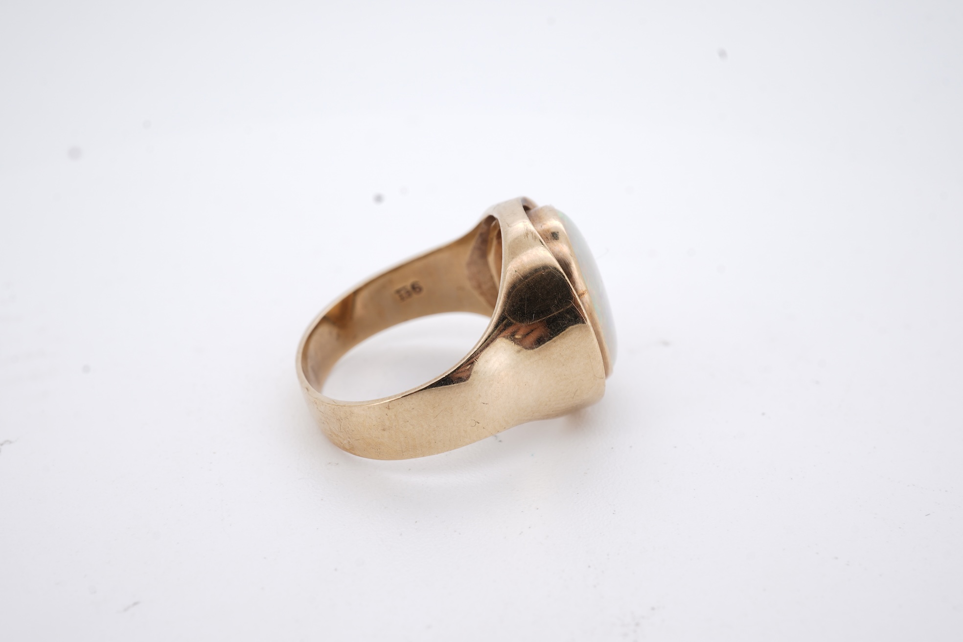 A 9ct and single stone cabochon white opal set ring, size K/L, gross weight 5 grams.